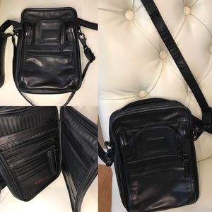 Black leather cross body bag by Tumi